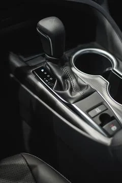 Car cup holders between back seats, close up view, luxury car interior Stock Photos