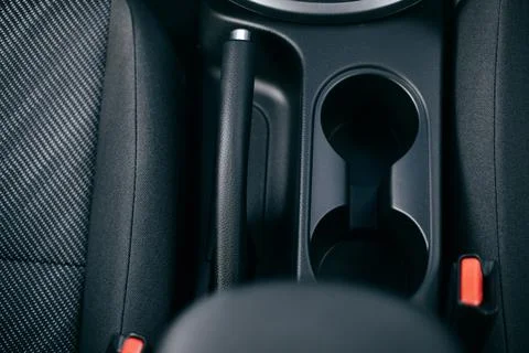 Car cup holders between back seats, close up view, luxury car interior Stock Photos