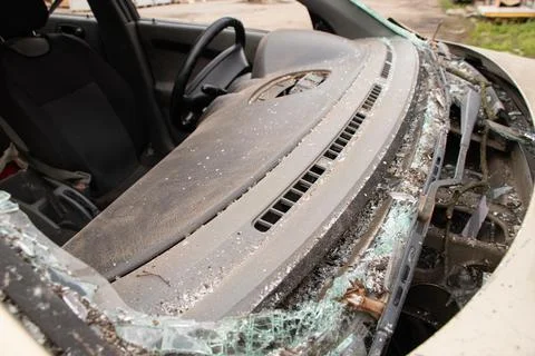 A car damaged by a blast wave from a drone strike near a residential buildi.. Stock Photos