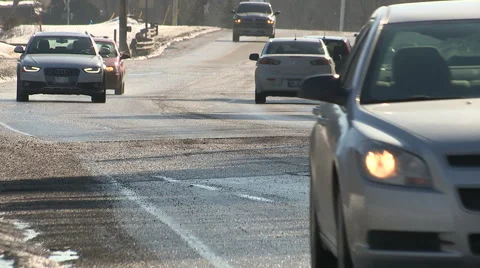 Car damaging large potholes on city streets Stock Footage 47857032