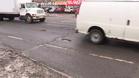 Car damaging large potholes on city streets Stock Footage 48826828