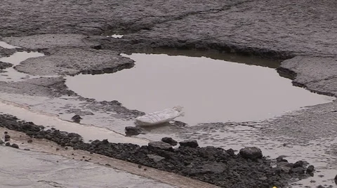 Car damaging large potholes on city streets Stock Footage 48827005