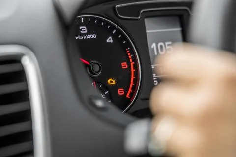 Car dashboard with amber engine light on Stock Photos