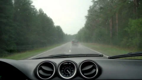 Car dashboard and front window with working wipers on the road in rainy day. Video stock 157207514
