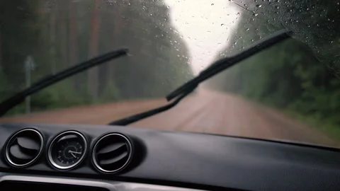 Car dashboard and front window with working wipers on the road in rainy day. Video stock 158175475