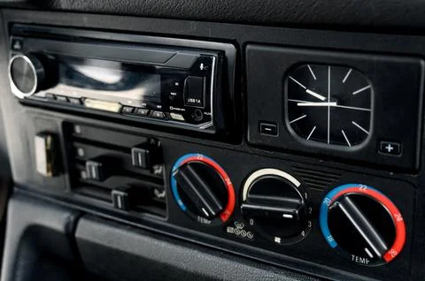 Car dashboard controls with audio system and climate settings displayed Stock Photos