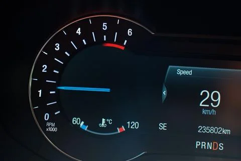 Car dashboard display with tachometer and digital speed readout Stock Photos