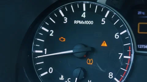 Car dashboard displaying check engine and low tire pressure warning lights Stock Footage 338031004