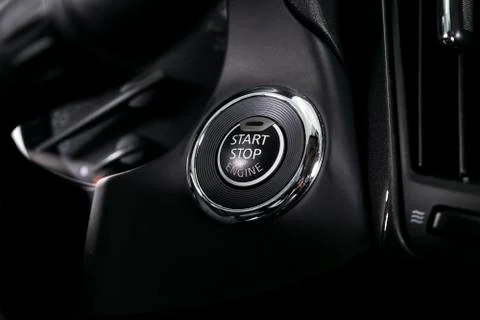 Car dashboard with focus on engine start stop button. Modern car interior det Stock Photos