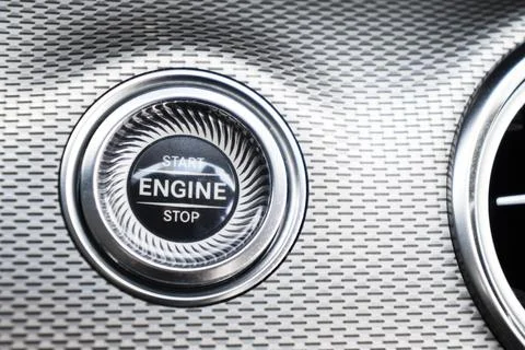 Car dashboard with focus on engine start stop button. Modern car interior d.. Foto stock