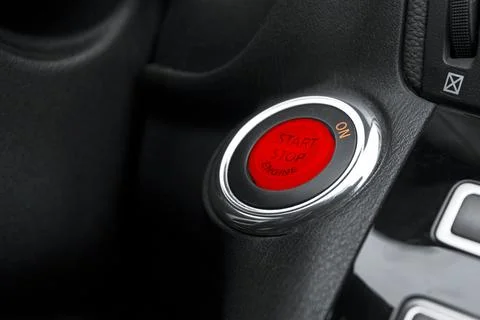 Car dashboard with focus on engine start stop button. Modern car interior d.. Foto stock