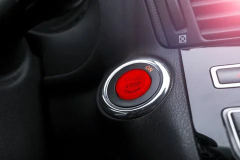 Car dashboard with focus on engine start stop button. Modern car interior d.. Stock Photos