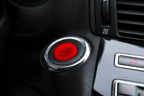 Car dashboard with focus on engine start stop button. Modern car interior d.. Foto stock