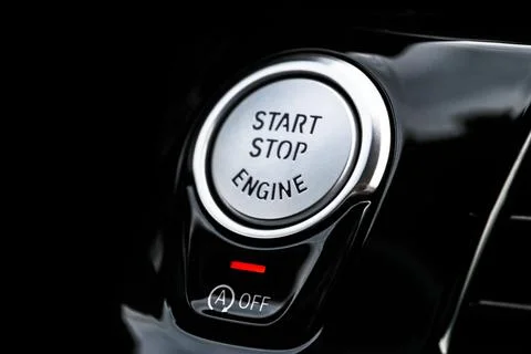 Car dashboard with focus on engine start stop button. Modern car interior d.. Stock Photos