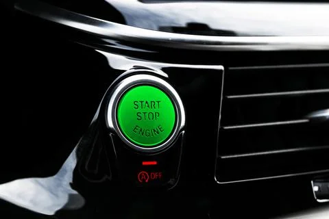 Car dashboard with focus on engine start stop button. Modern car interior d.. Stock Photos