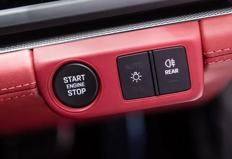 Car dashboard with focus on engine start stop button Stock Photos