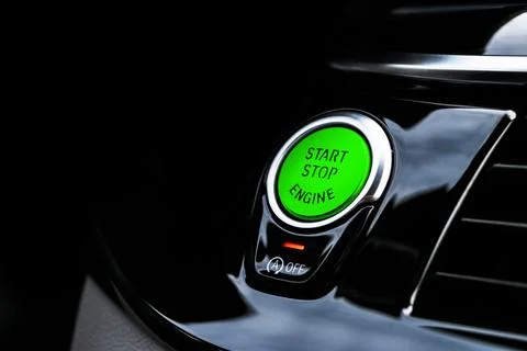 Car dashboard with focus on green engine start stop button. Modern car inte.. Stock Photos