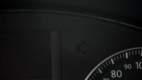 Car dashboard indicator shows left turn signal at night while vehicle is in moti Stock Footage 335333818