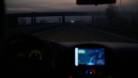 Car dashboard with navigation system showing highway at dusk, driving at night Stock Footage 329322327