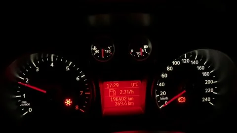 Car dashboard at night, the tachometer needle moving Stock Footage 324786527