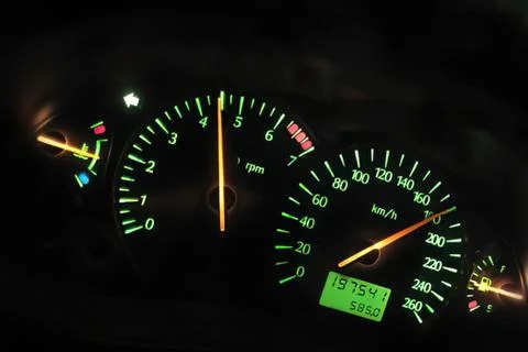 Car dashboard speedometer and tachometer at night Stock Photos