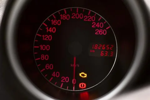 Car dashboard speedometer with check engine light symbol glowing  red backgro Fotos de archivo