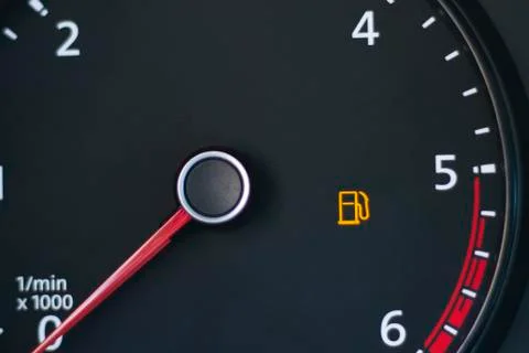 Car. Dashboard. Tachometer sensor, arrow on zero. Empty tank sign blinking. T Stock Photos