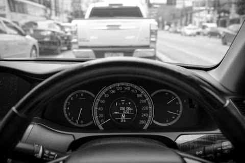 Car dashboard in traffic, selective focus, black and white photography Stock Photos