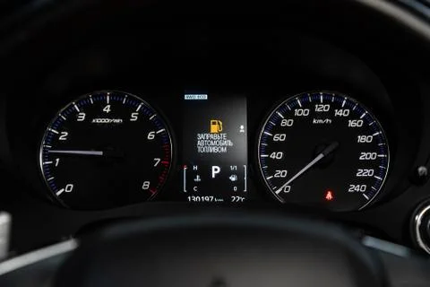 Car dashboard with white  backlight: Odometer, speedometer, tachometer, fuel  Stock Photos