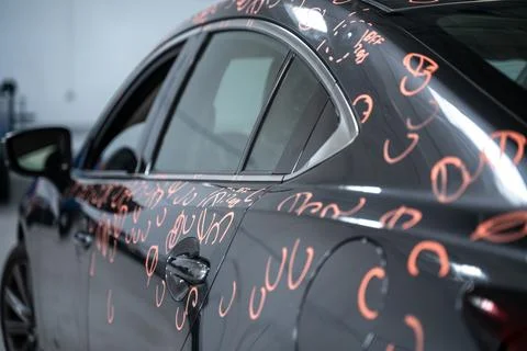 Car with dent marks in to process of Repairing Hail Damage in car body shop Stock Photos