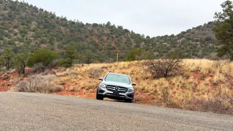 Car on a Desert Mountain Road Stock Footage 276192759