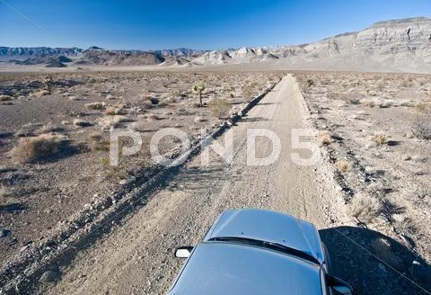 Car On Desert Road In Death Valley National Park, California, Usa