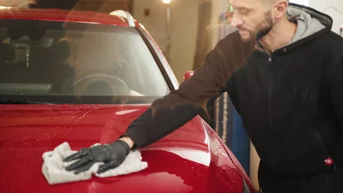 Car detailing and cleaning concept. Good-looking young male car wash worker Stock Footage 234018467