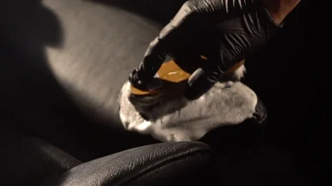 Car Detailing. Close shot of hands cleaning car seat with a brush and foam Stock Footage 82624286