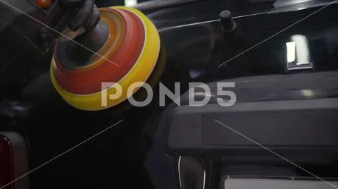 Car detailing - Hands with orbital polisher in auto repair shop. Selective focus Stock Photos