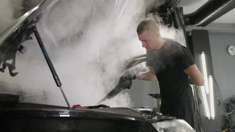 Car detailing maintenance, cleaning engine with hot steam. Stock Footage 244860523