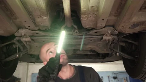 Car diagnostics. an auto mechanic inspects a car. auto repair shop. breaking. Stock Footage 204083286