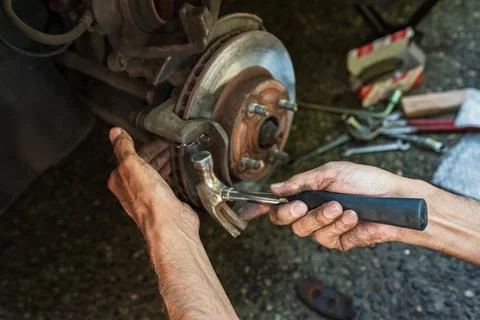 Car disk brake pad replacement service by hand of mechanic man. Auto mechanic Foto stock