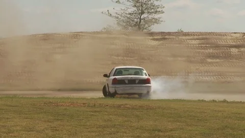 Car does doughnut then drifts on track  Video stock 76940345