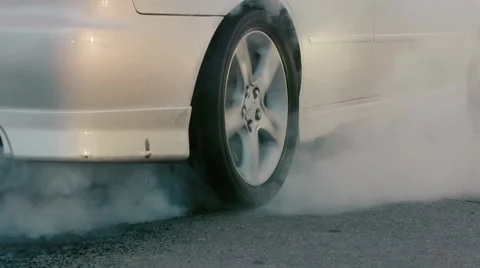 The Car Does Drift On Asphalt.Tire Smoking Heavily, Close-Up. Slow motion Stock Footage 54672881