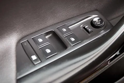 Car door armrest control panel with power window switches, side-mirror adjust Stock Photos