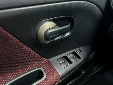 This car door control panel features a sleek design with window controls and  Stock Photos