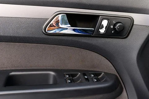 Car door handle. Inside the drivers door of a new car with a window lifter. A Photos