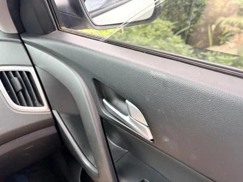 Car door handle with window control buttons. Photos
