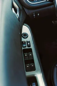 Car door interior with window controls and mirror switch Stock Photos