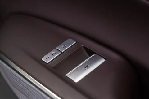 Car door lock unlock button close up. Modern car door lock. Door control pane Stock Photos