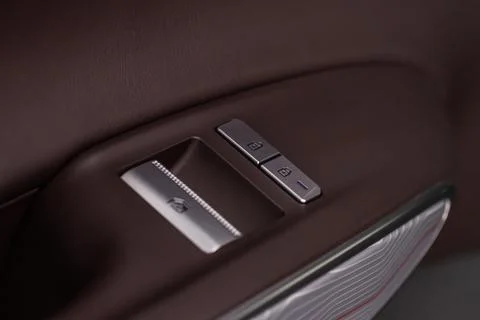 Car door lock unlock button close up. Modern car door lock. Door control pane Stock Photos