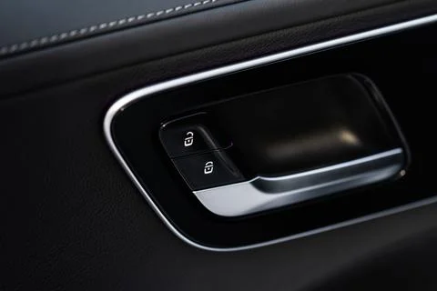 Car door lock unlock button close up. Modern car door lock. Door control pane Stock Photos