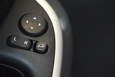 Car door lock, window button and side mirror adjuster button on a car. Photos