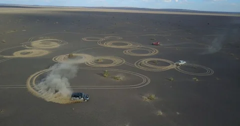 Car draws circles in the sand drift in the desert Stock Footage 122137755